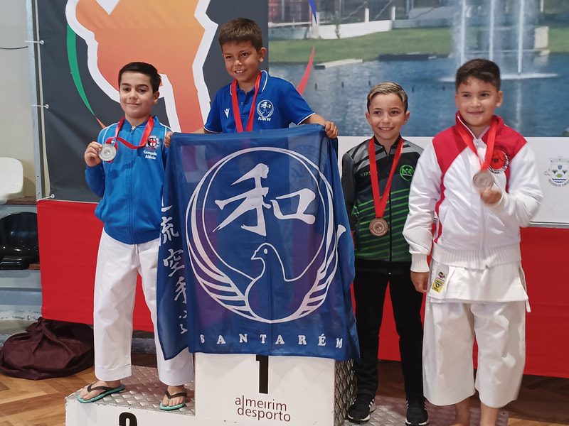 AIKW athletes on the podium with the association's flag